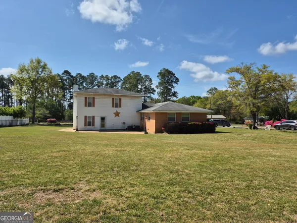 a front view of a house with a garden