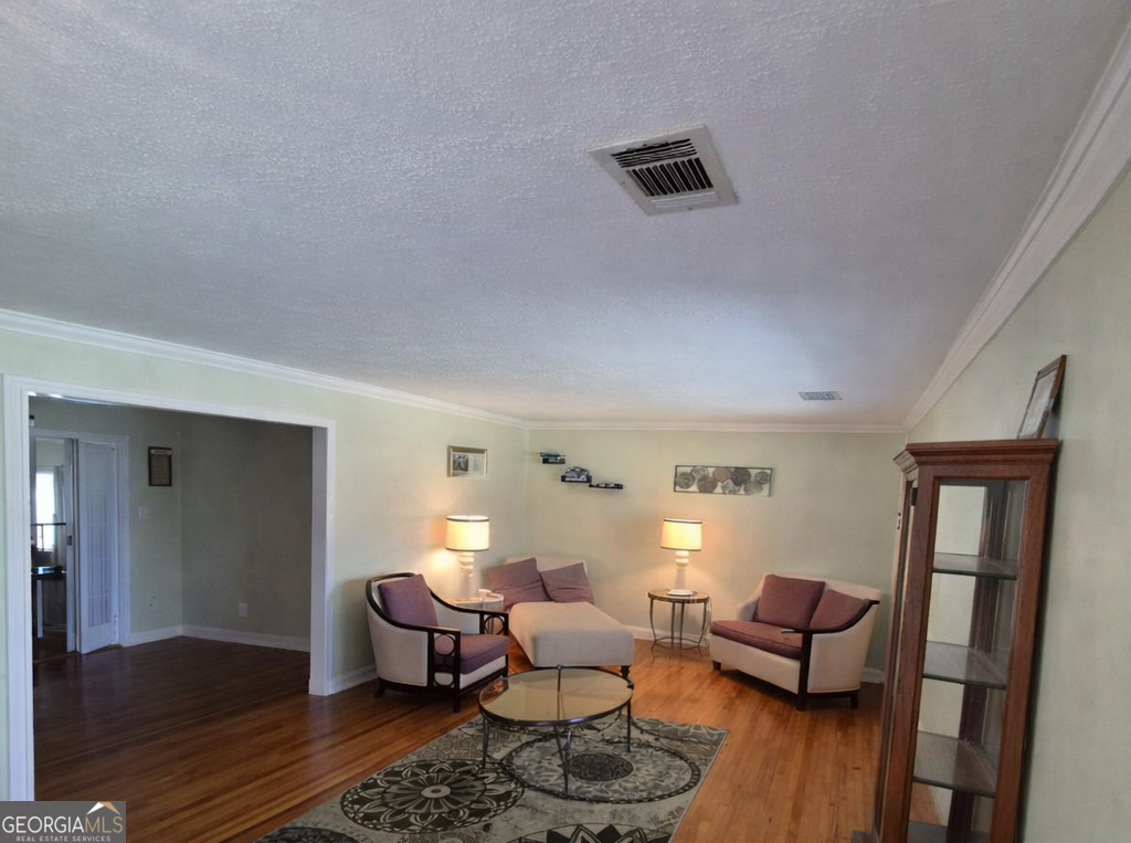 13 Marshall Street Butler, GA 31006 - Photo 10 of 27 a living room with furniture and wooden floor