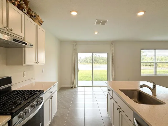 a kitchen with a sink and a stove top oven