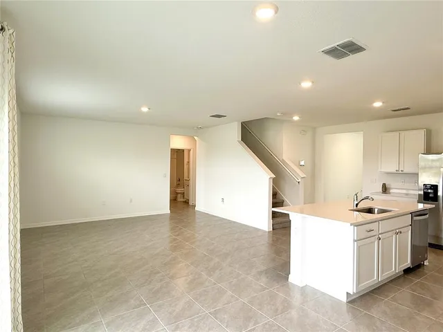 a view of a kitchen with a sink and cabinets