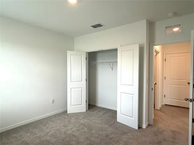 an empty room with closet area