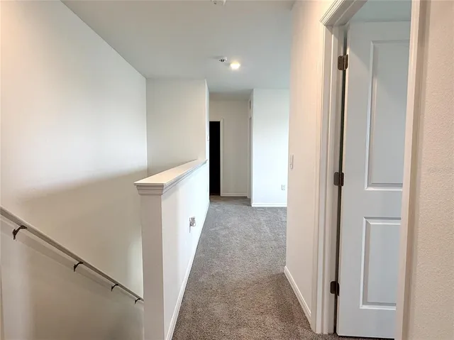 a view of a hallway with hallway and stairs