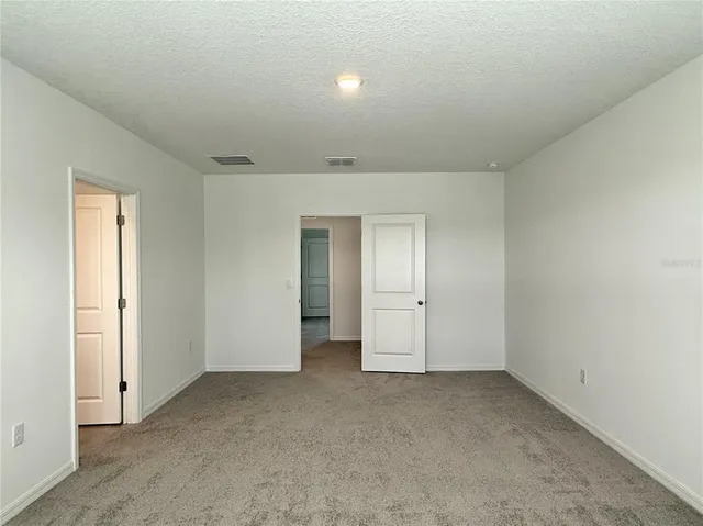 an empty room with closet area