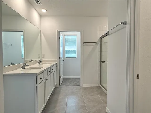 a bathroom with a double vanity sink a and mirror