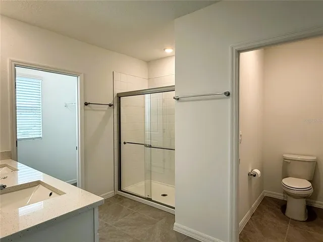 a bathroom with a shower and a toilet