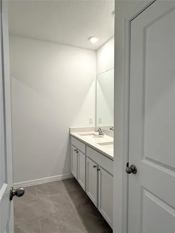 a bathroom with a double vanity sink and mirror