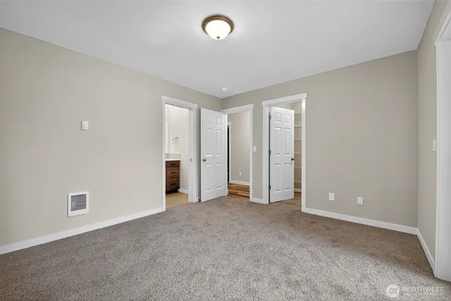 an empty room with closet and a window