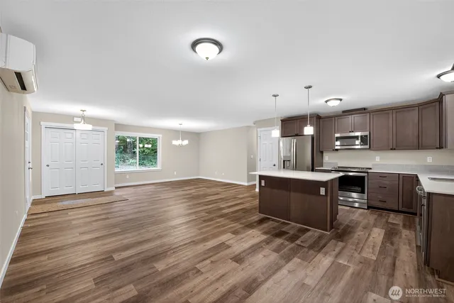 a kitchen with stainless steel appliances kitchen island wooden cabinets and granite counter tops