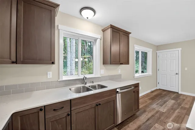 a kitchen with a sink cabinets and window