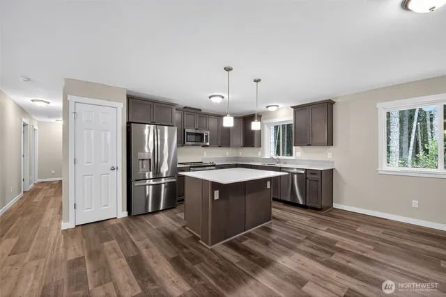 a kitchen with stainless steel appliances granite countertop a stove and a refrigerator