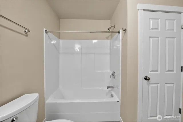 a bathroom with a shower and a toilet