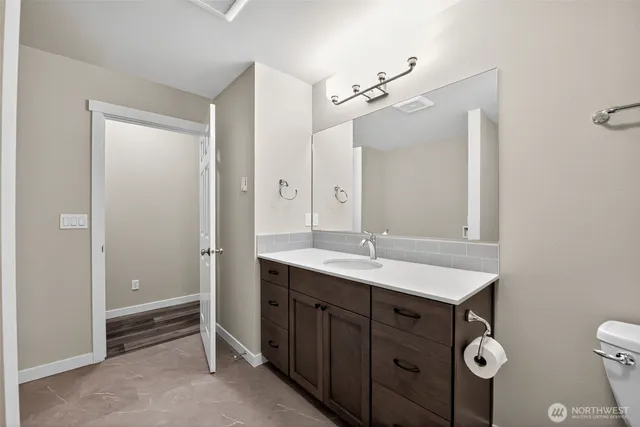 a bathroom with a double vanity sink and mirror