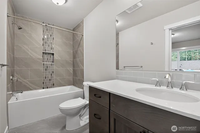 a bathroom with a sink toilet vanity and shower