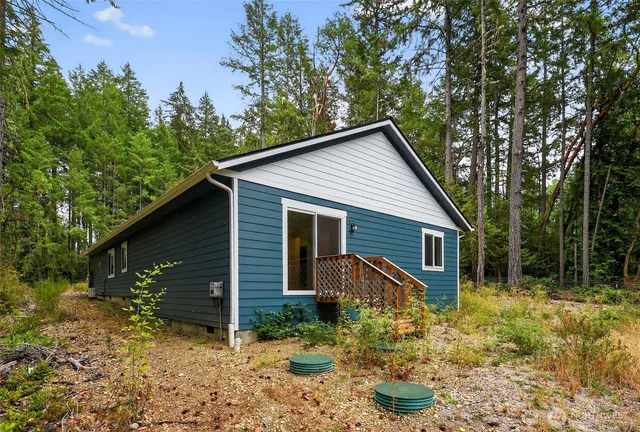a view of house with backyard and garden
