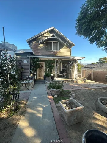 a view of a house with swimming pool and sitting area