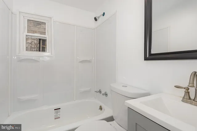 a white bath tub sitting next to a white sink
