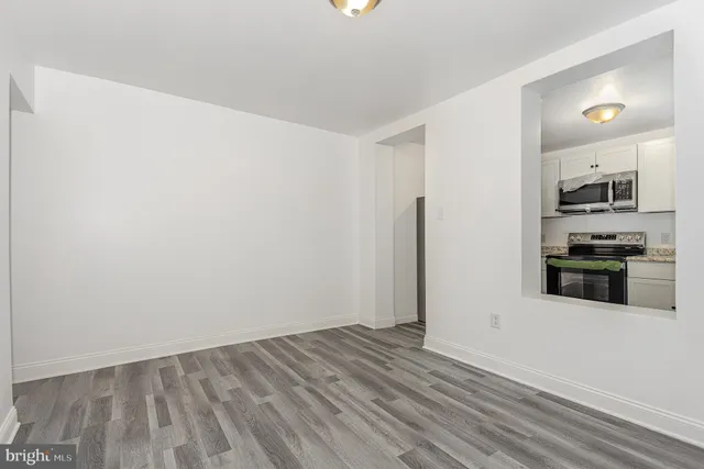 a view of a kitchen with wooden floor and a sink