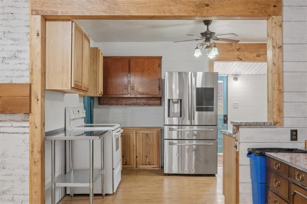 1491 Booze Mountain Road Silver Creek, GA 30173 - Photo 13 of 41 a kitchen with stainless steel appliances granite countertop a refrigerator and a stove top oven