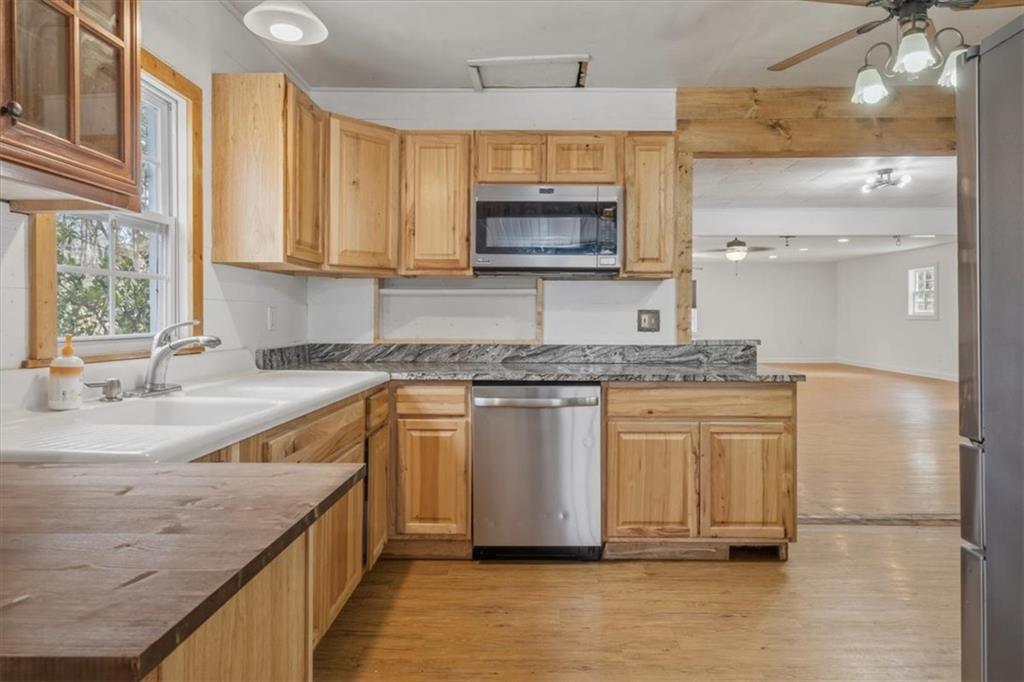 1491 Booze Mountain Road Silver Creek, GA 30173 - Photo 15 of 41 a kitchen with stainless steel appliances granite countertop a sink and a stove