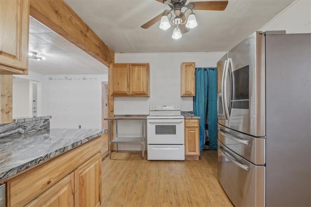 1491 Booze Mountain Road Silver Creek, GA 30173 - Photo 16 of 41 a kitchen with a refrigerator and a sink