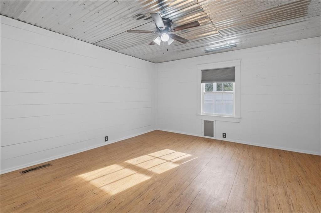 1491 Booze Mountain Road Silver Creek, GA 30173 - Photo 21 of 41 an empty room with wooden floor and windows