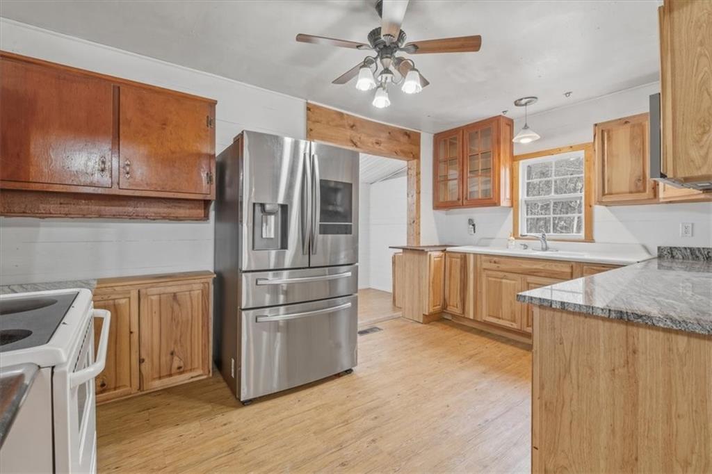 1491 Booze Mountain Road Silver Creek, GA 30173 - Photo 3 of 41 a kitchen with stainless steel appliances granite countertop a refrigerator a stove a sink and a microwave