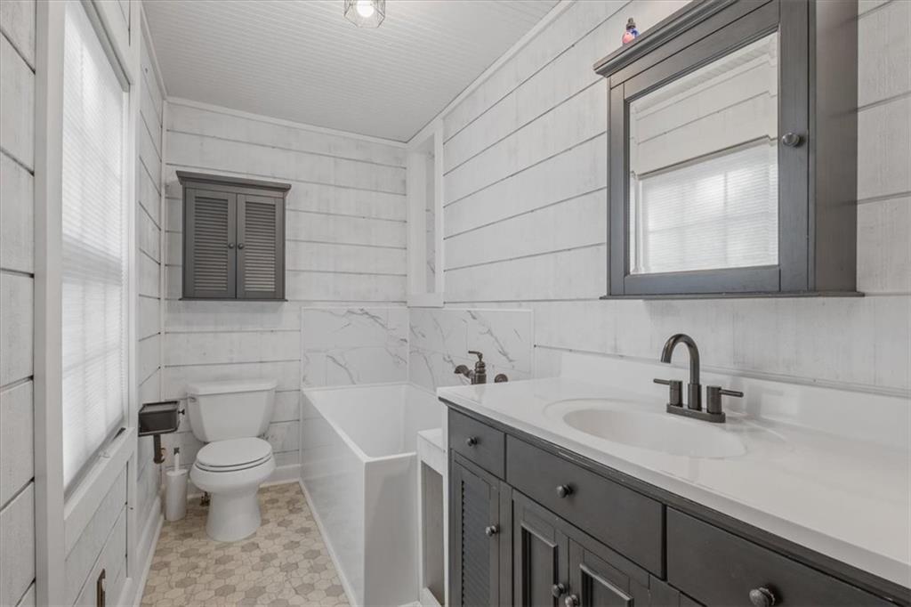 1491 Booze Mountain Road Silver Creek, GA 30173 - Photo 4 of 41 a bathroom with a sink a toilet and mirror