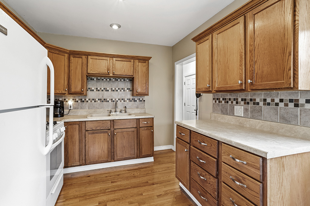 302 East Division Street Lemont, IL 60439 - Photo 16 of 26 a kitchen with stainless steel appliances granite countertop a refrigerator sink and cabinets
