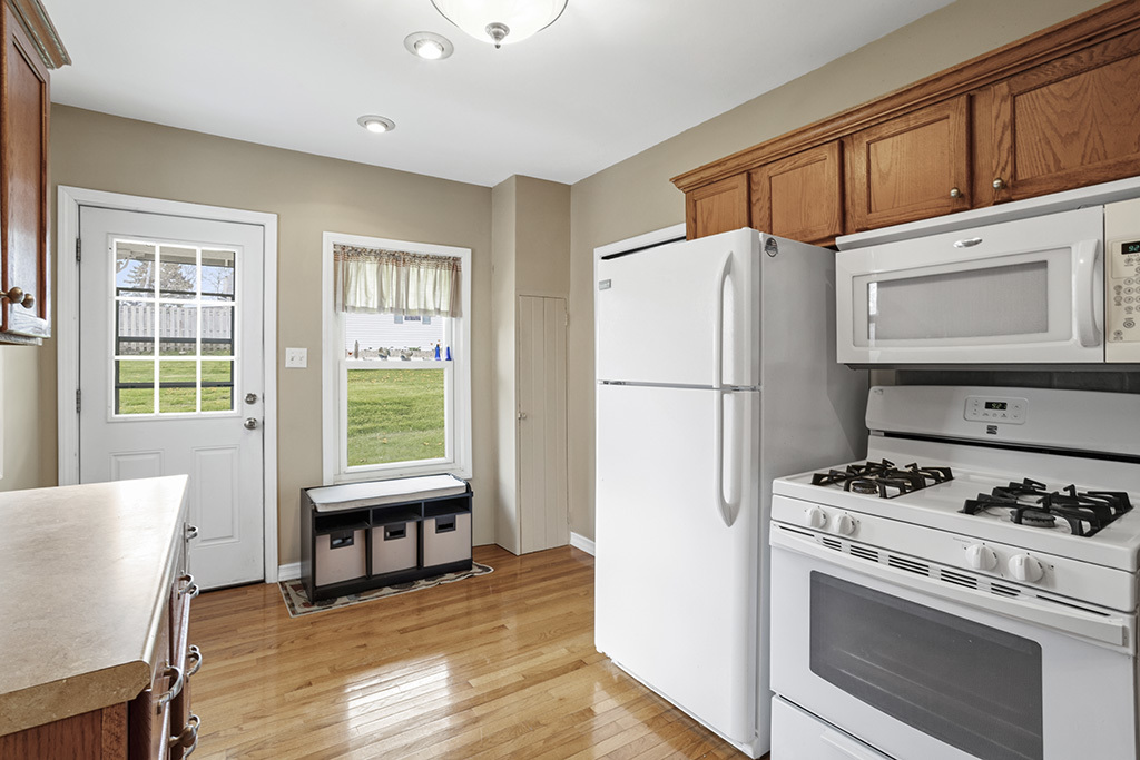 302 East Division Street Lemont, IL 60439 - Photo 17 of 26 a kitchen with stainless steel appliances granite countertop a refrigerator sink and stove