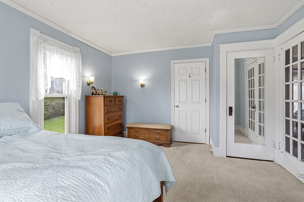 302 East Division Street Lemont, IL 60439 - Photo 19 of 26 a bedroom with a large bed and a chandelier