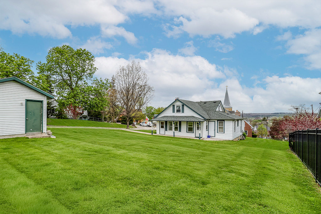 302 East Division Street Lemont, IL 60439 - Photo 6 of 26 a view of a house with a big yard and large trees