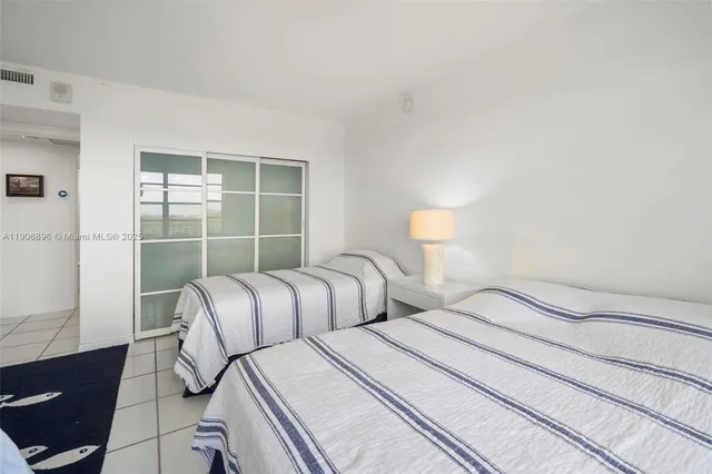 a bedroom with two beds and a window