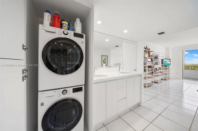 a utility room with sink dryer and washer