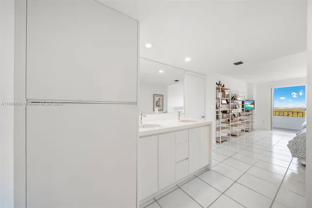 a kitchen with a sink and chairs