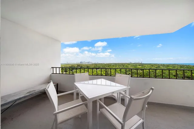 a view of a terrace with furniture and city view