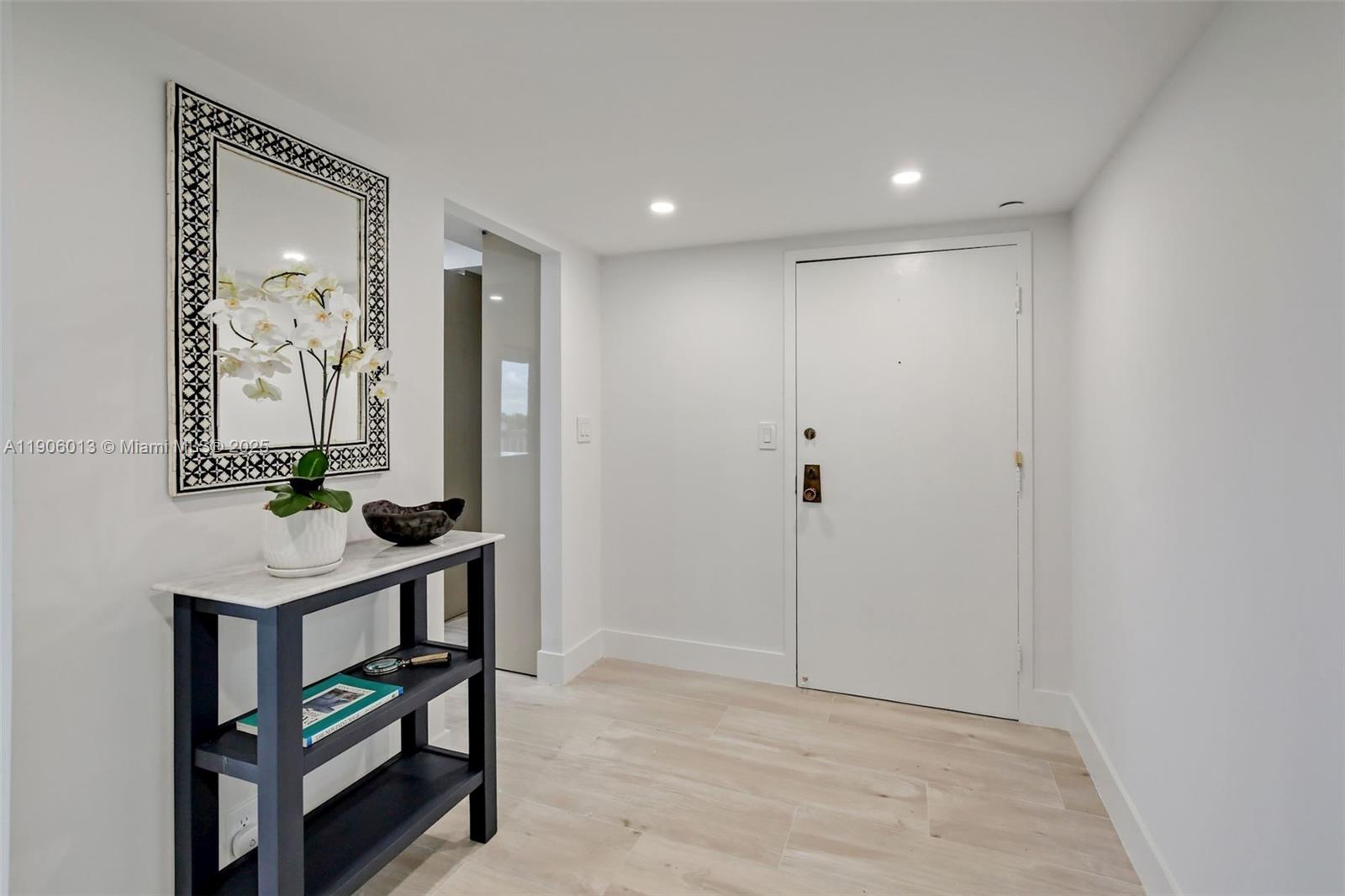 1111 Crandon Boulevard, Unit A507 Key Biscayne, FL 33149 - Photo 1 of 23 a view of a hallway with front door and wooden floor