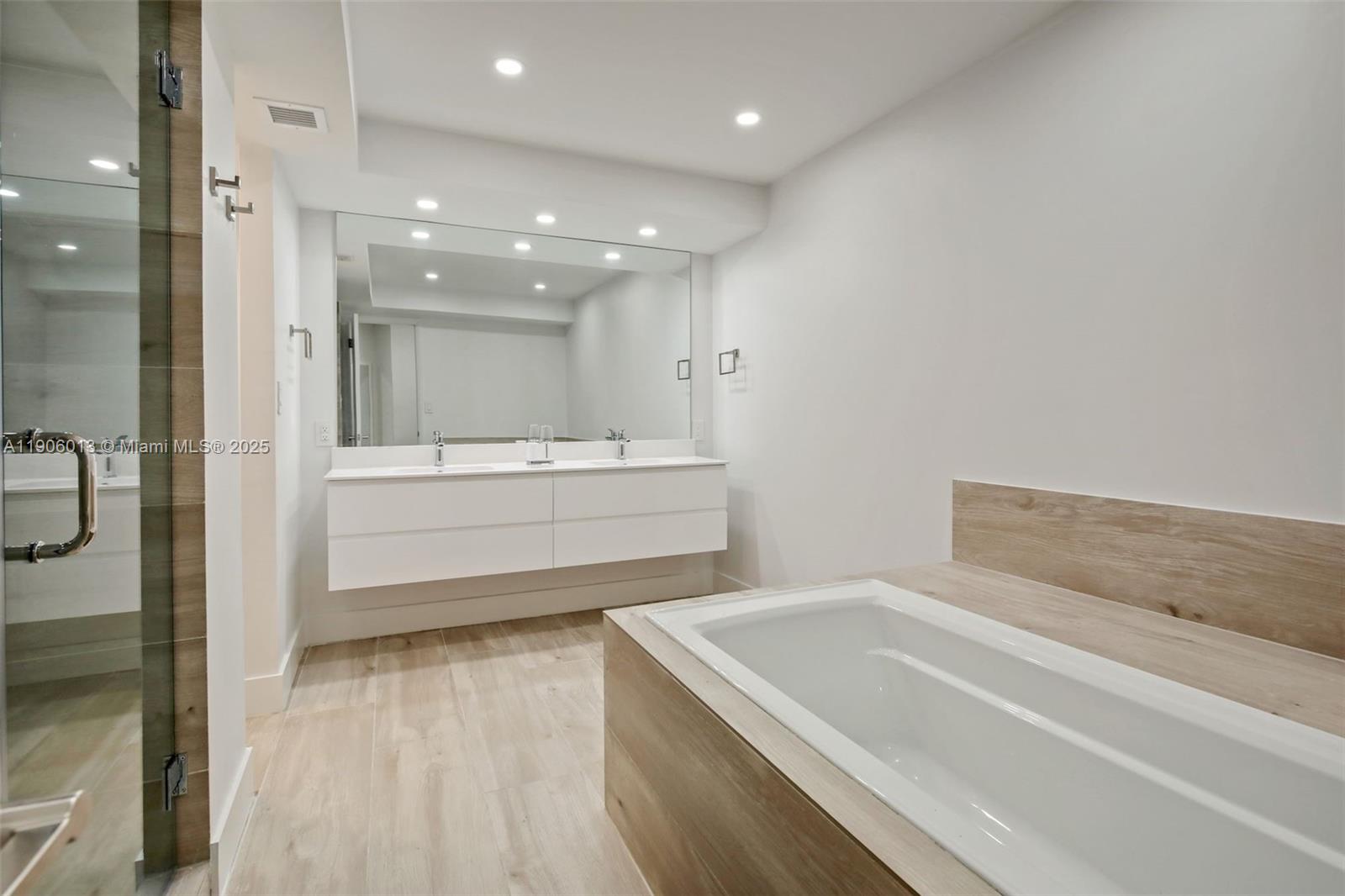 1111 Crandon Boulevard, Unit A507 Key Biscayne, FL 33149 - Photo 12 of 23 a bathroom with a bathtub and a sink