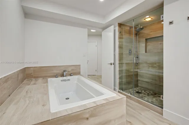 a bathroom with a bathtub and a shower