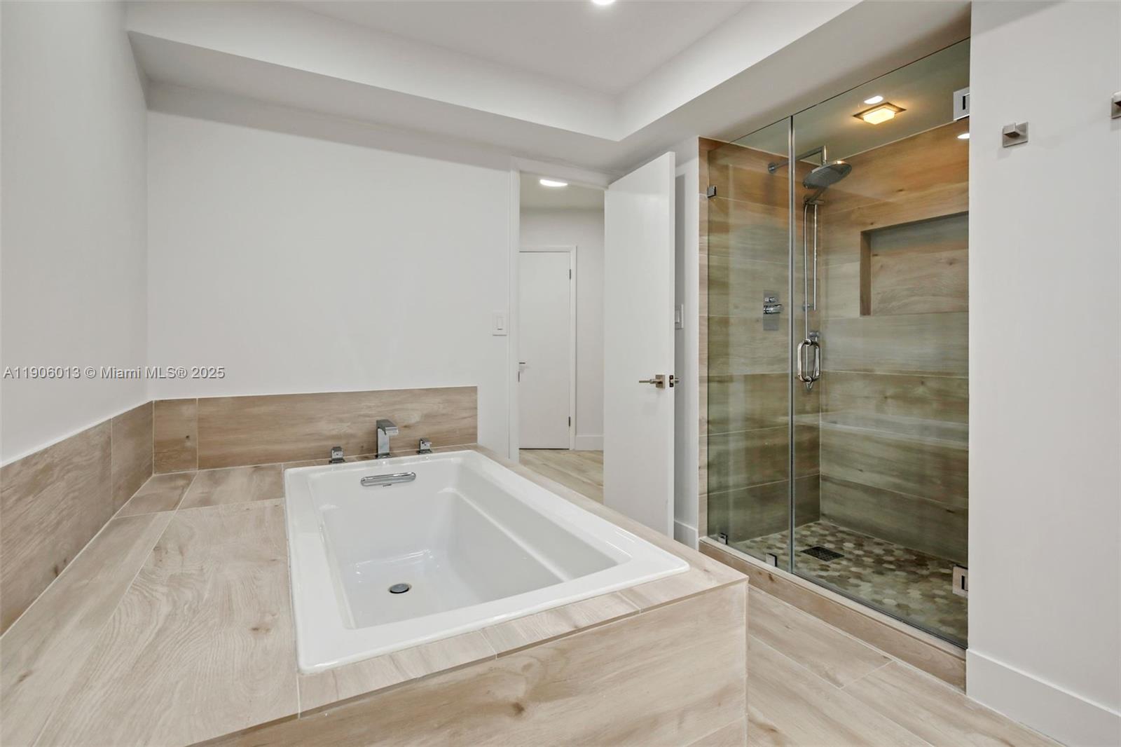 1111 Crandon Boulevard, Unit A507 Key Biscayne, FL 33149 - Photo 13 of 23 a bathroom with a bathtub and a shower