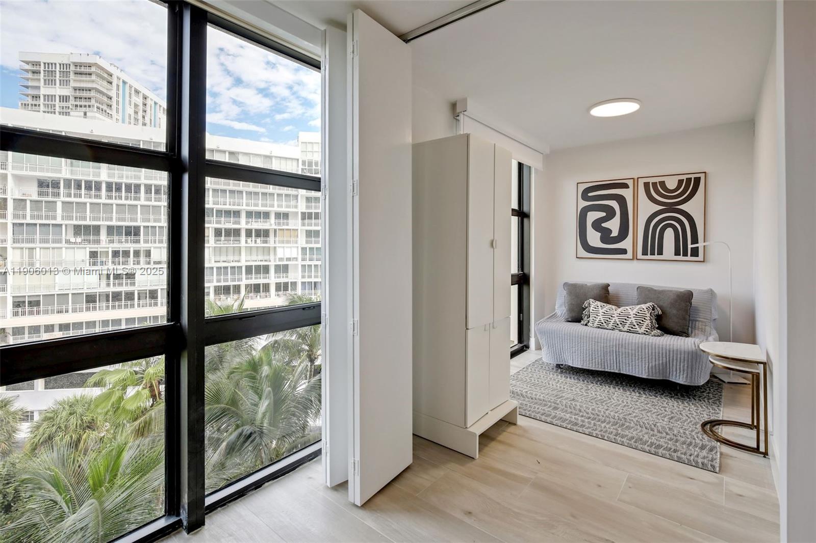 1111 Crandon Boulevard, Unit A507 Key Biscayne, FL 33149 - Photo 6 of 23 a living room with furniture and a large window
