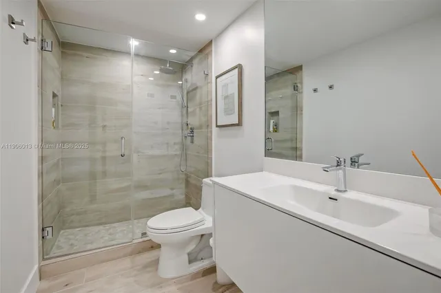 a bathroom with a sink toilet and shower
