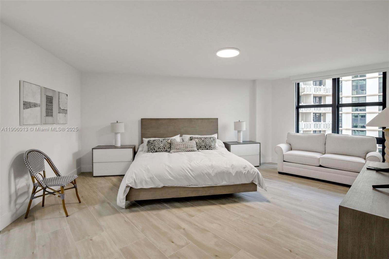 1111 Crandon Boulevard, Unit A507 Key Biscayne, FL 33149 - Photo 10 of 23 a bedroom with a bed and a couch