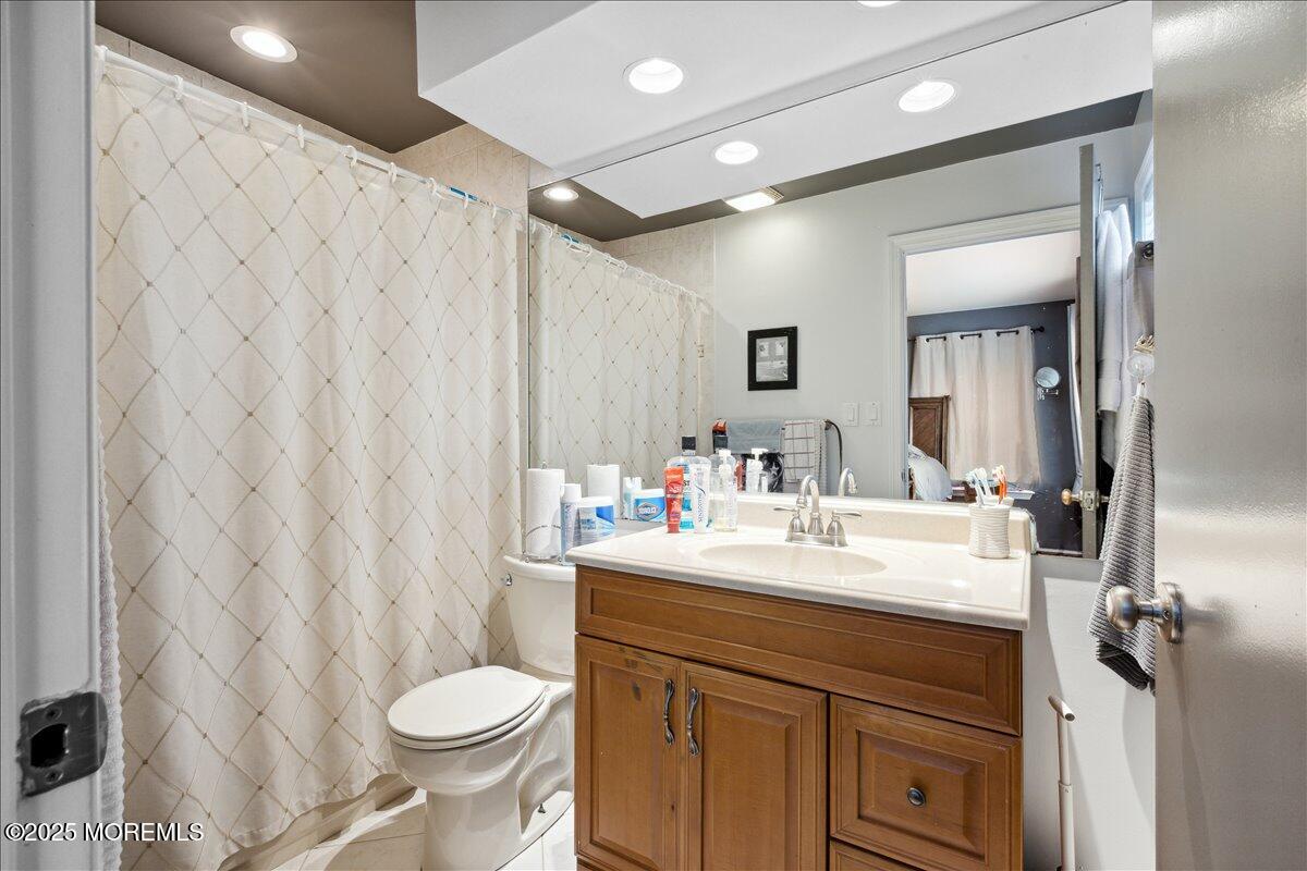 425 Winterberry Court Howell, NJ 07731 - Photo 13 of 17 a bathroom with a sink vanity mirror and toilet