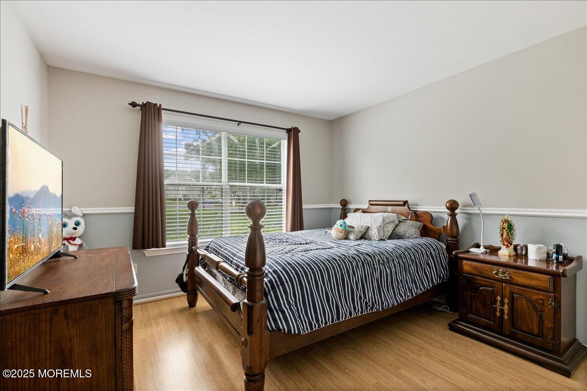 425 Winterberry Court Howell, NJ 07731 - Photo 14 of 17 a bedroom with a bed and a dresser next to a window