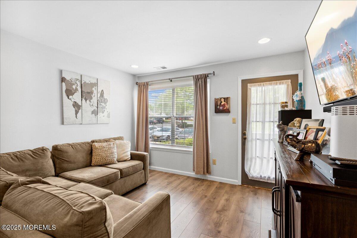 425 Winterberry Court Howell, NJ 07731 - Photo 6 of 17 a living room with furniture a flat screen tv and a window