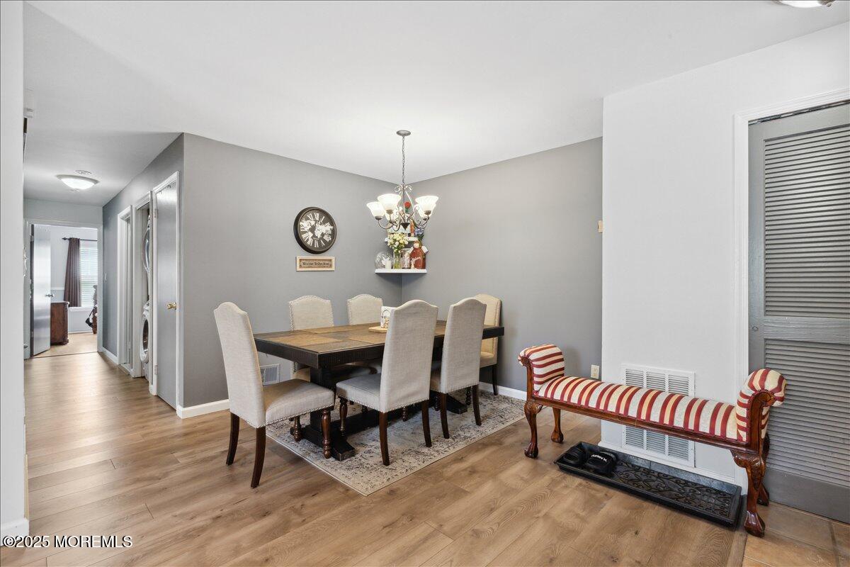 425 Winterberry Court Howell, NJ 07731 - Photo 8 of 17 a view of a dining room with furniture and wooden floor