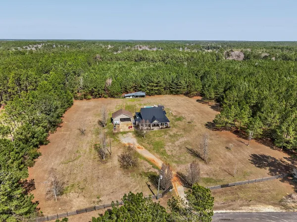 a view of a house with backyard patio and swimming pool