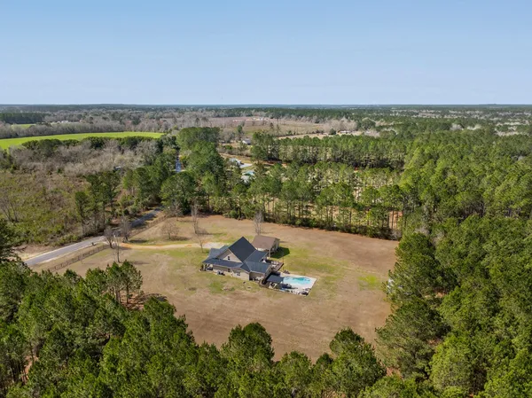 a view of a house with swimming pool and sitting area