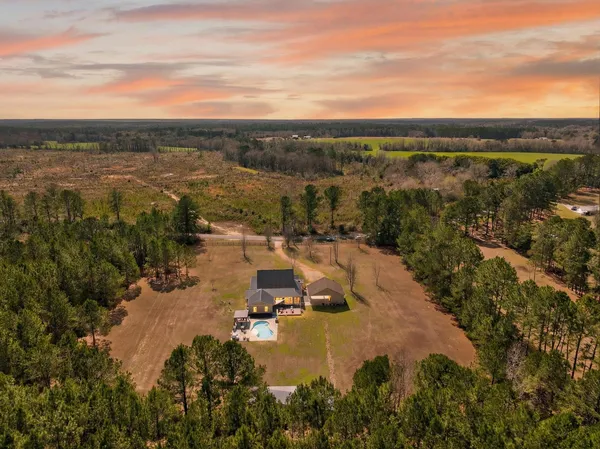aerial view of a house with a yard and sitting area
