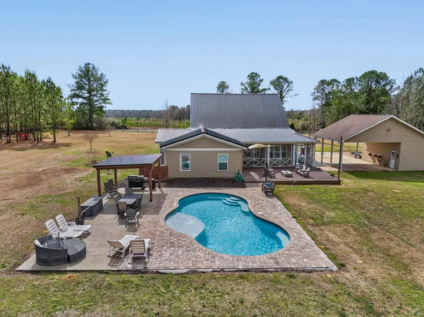 a view of a dining room with furniture and a chandelier